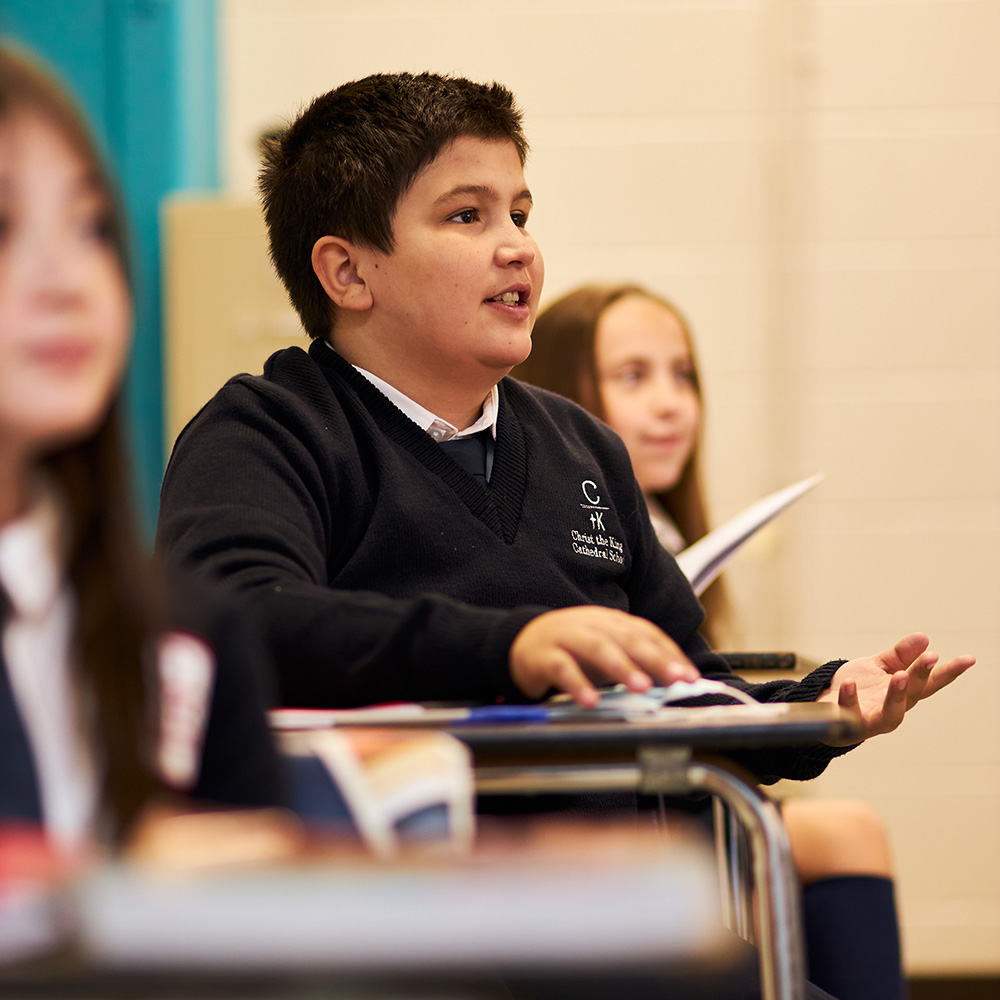 middles school boy learning christ the king catholic school